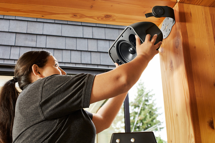 Technician installing a Sonos outdoor speaker